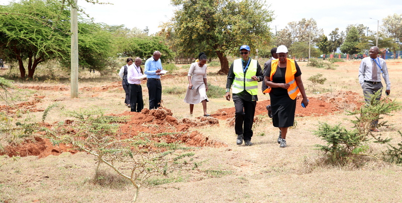 Members of the University touring the site, led by the Vice Chancellor